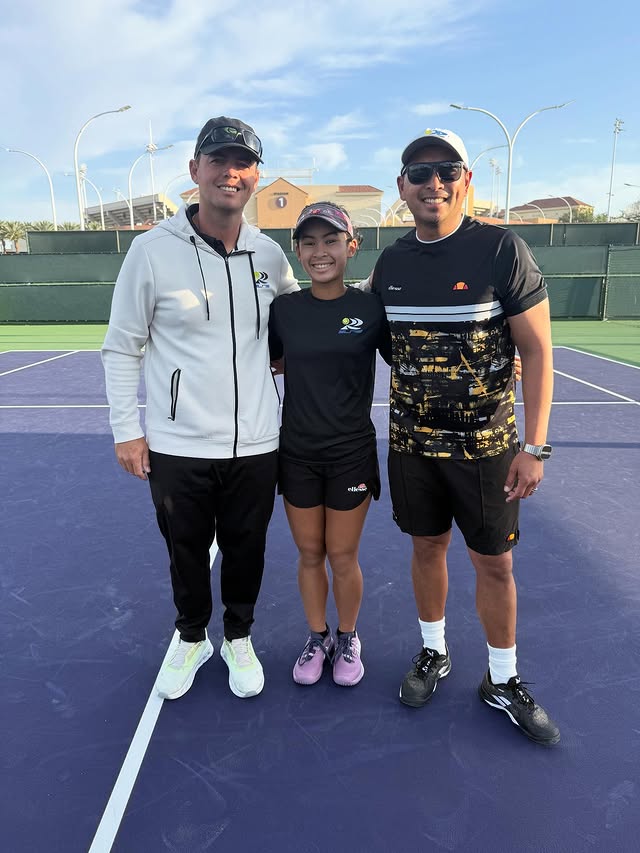 Coach and players on purple court